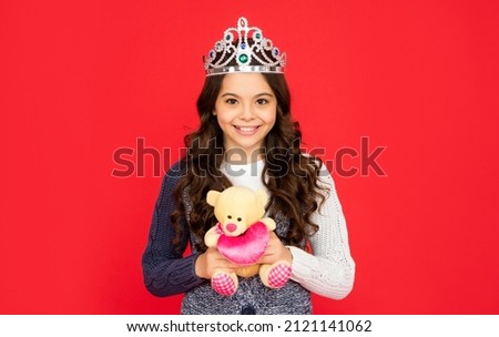 happy child in queen crown. princess in tiara. kid hold bear toy. teen girl wear diadem