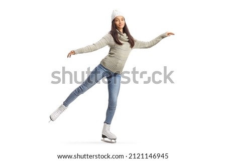 Bautiful young woman in casual clothes ice skating and looking at camera isolated on white background