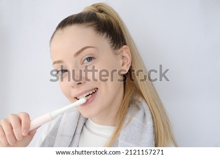 pretty woman brushing her teeth