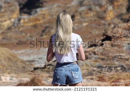Blonde girl looking away in rocky mountains