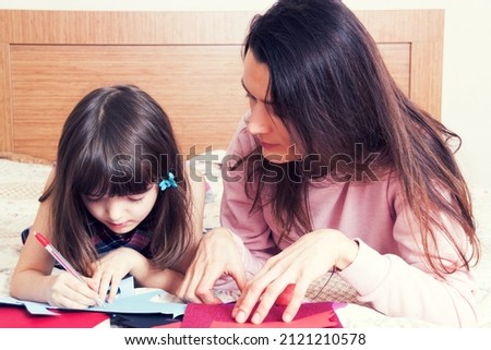 Mom with the daughter reading together