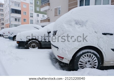Snow falling on cars. Winter. Snowfall.