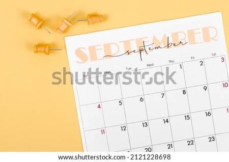 The September 2022 and wooden push pin on yellow background. Royalty-Free Stock Photo #2121228698