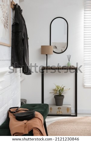 Hallway interior with console table and stylish decor