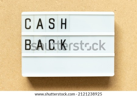 Lightbox with word cash back on wood background