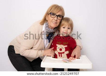 Happy grandmother hugging little grandchild over white background. Family concept.