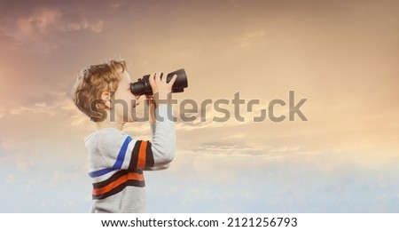 A child with binoculars  ready for getting knowledge  Royalty-Free Stock Photo #2121256793