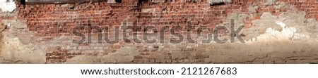 Old factory brick wall texture with some concrete plaster left on it. Royalty-Free Stock Photo #2121267683