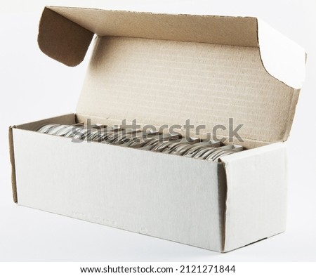 Storage cardboard box with opened lid for silver investment coins in round plastic boxes