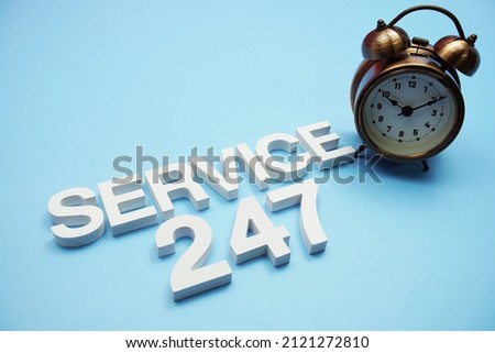 24 Hrs 7 Days Service alphabet letters on blue background