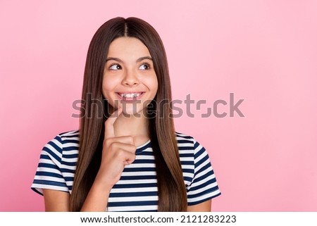 Photo of clever dreamy girl wear striped outfit finger chin looking empty space isolated pink color background