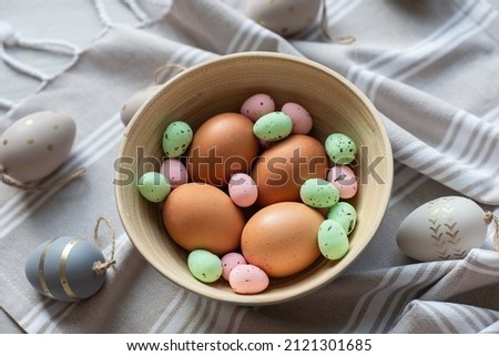 Flat lay photo of beautiful easter eggs in wooden basket