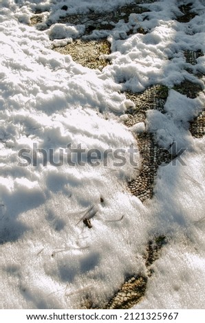 Ancient Hellenistic mosaic floor covered with snow after a winter blizzard