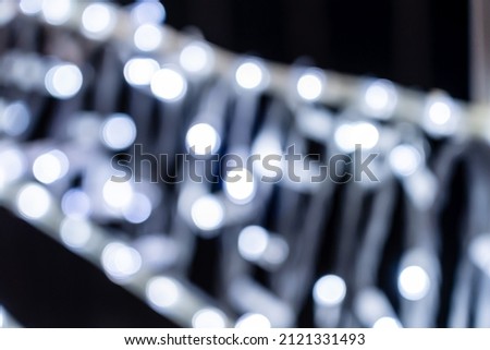 Romantic glitter vintage lights with black background. Defocused