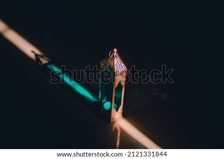 Ornamental Arabic lantern with burning candle glowing at night. Festive greeting card, invitation for Muslim holy month Ramadan Kareem(Eid Holiday) Dark background.
 Royalty-Free Stock Photo #2121331844