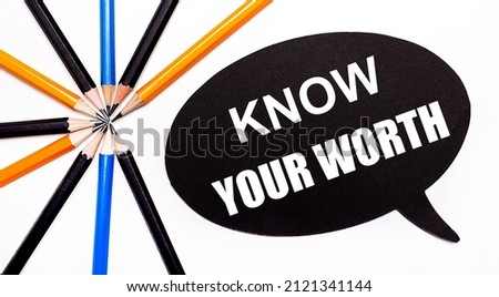 On a light background, multi-colored pencils and on a black background a white card with the text KNOW YOUR WORTH