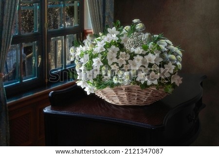 Still life with basket of white flowers
