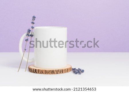 Mockup mug on wooden coaster at purple background, blank cup for logo or design Royalty-Free Stock Photo #2121354653