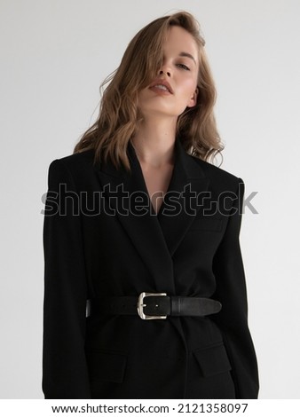 Natural look. Beauty model woman . Model test portrait with young beautiful fashion model posing on grey background. Blond woman in a black blazer . Natural makeup Royalty-Free Stock Photo #2121358097