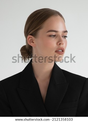 Natural look. Beauty model woman . Model test portrait with young beautiful fashion model posing on grey background. Blond woman in a black blazer . Natural makeup Royalty-Free Stock Photo #2121358103