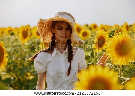 woman portrait walks through a field of sunflowers unaltered