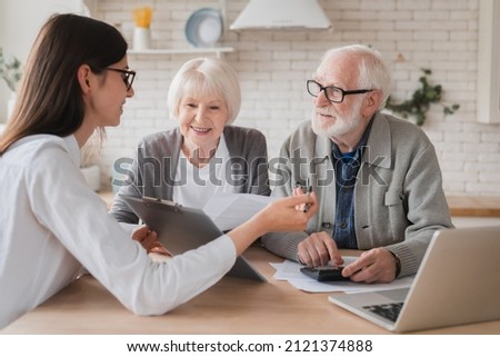 Successful deal. Lawyer financial adviser helping consulting showing contract mortgage loan credit business startup, signing documents by elderly senior old grandparents couple at home