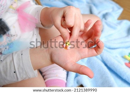 colored plasticine figurine on a child's hand