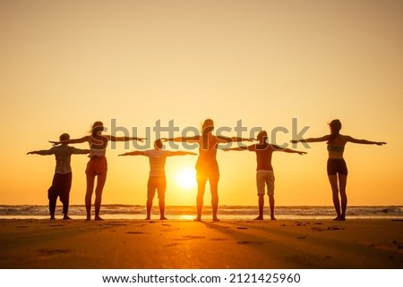 six health people in stand hatha position with hand up raced and breath full chest in Goa India beach at sunset Royalty-Free Stock Photo #2121425960