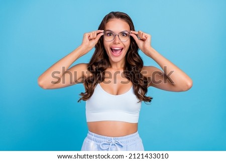Photo of positive pretty lady open mouth omg reaction wear specs sportswear set isolated blue color background