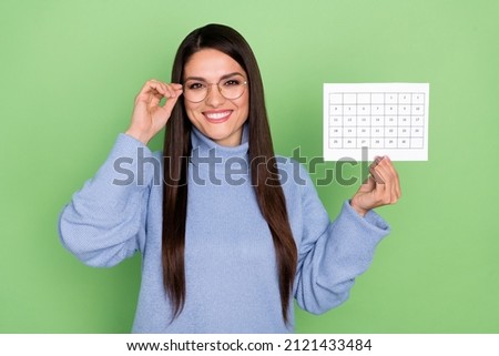 Photo of ceo mature brunette lady show calendar wear blue pullover isolated on green color background