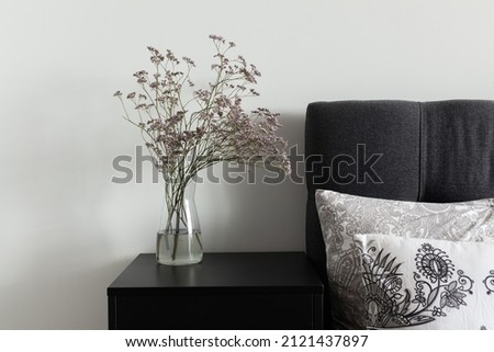 nice delicate bouquet in a beautiful vase at home interior, bedroom 