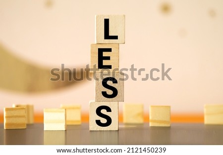 Less word on wooden cubic blocks. Spend less or cut costs business concept