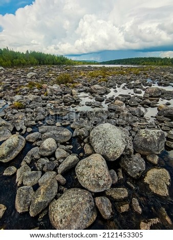 stones in water sky and clouds, beautiful photo digital picture , picture taken in Sweden, Europe , Digital created image Picture