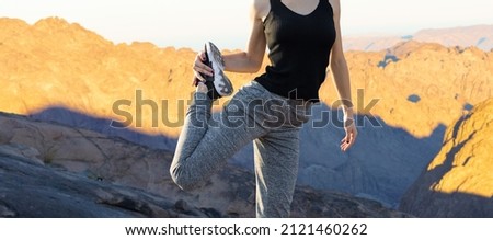A young slim athletic girl in sportswear performs a set of exercises. Fitness and healthy lifestyle.