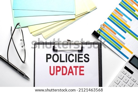 POLICIES UPDATE text on the paper sheet with chart,color paper and calculator