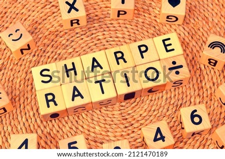 SHARPE RATIO word text from wooden cube block letters. Sharpe ratio measures the performance of investment such as a security or portfolio compared to a risk-free asset, after adjusting for its risk. Royalty-Free Stock Photo #2121470189