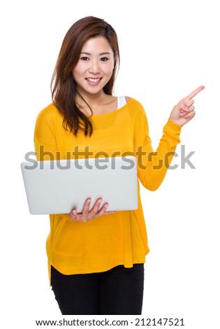 Young woman use of laptop computer and finger point aside