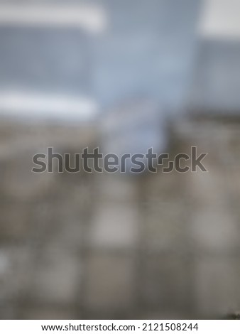 Defocused abstract background of a big grey stone lying on the wall