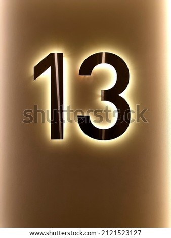 the number thirteen dark colors attached to the doors of the room

