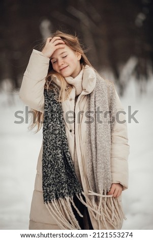  girl having fun in the winter forest. High quality photo