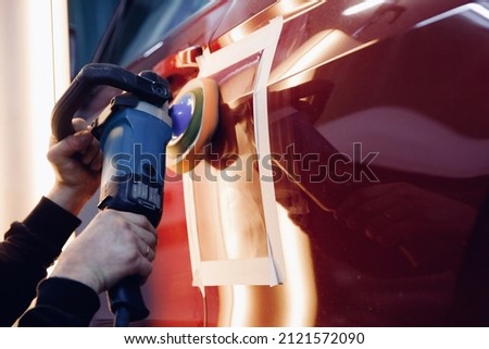 Master mechanic removal of dents defects auto repairman grinding automobile car body. Royalty-Free Stock Photo #2121572090