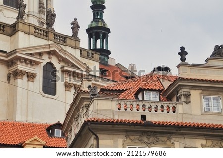Background with part of the facade of an old building with ornate balconies, turrets and roofs. 