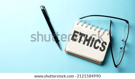 ETHICS text written on notepad on the blue background