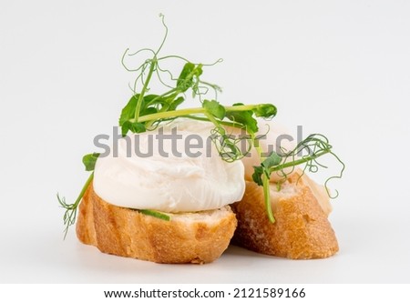 Poached egg on bread isolated on white background. Sandwich with  boiled egg isolated on white. Poached egg on toast.  Royalty-Free Stock Photo #2121589166