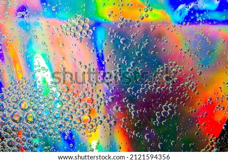 Bubbles in oil in water on a rainbow abstract macro background.