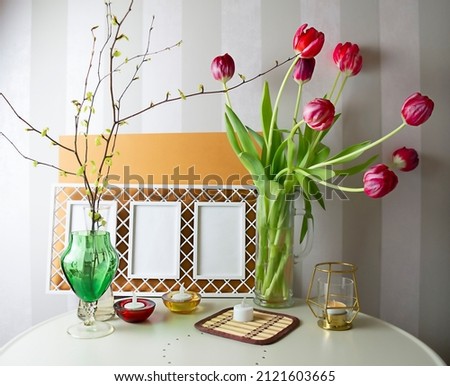 Spring still life, mockup, bouquet of tulips and photo frames, selective focus. High quality photo