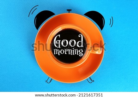 Coffee in cup on light blue background, top view. Good Morning