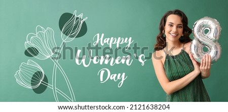 Smiling young woman with balloon in shape of figure 8 on green background. International Women's Day celebration Royalty-Free Stock Photo #2121638204