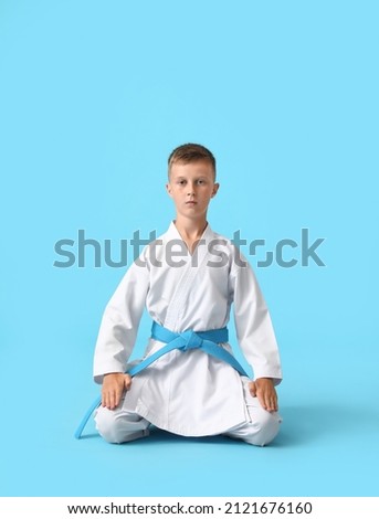 Little boy in karategi on color background Royalty-Free Stock Photo #2121676160