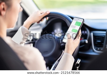 Using phone while driving car. Distracted driver texting while in vehicle. Irresponsible woman checking sms message with mobile cellphone in traffic. Holding smartphone in hand. Auto accident concept. Royalty-Free Stock Photo #2121678566